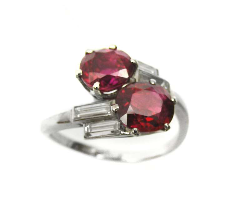 Platinum and ruby 2 stone and baguette diamond crossover ring, open set in platinum.